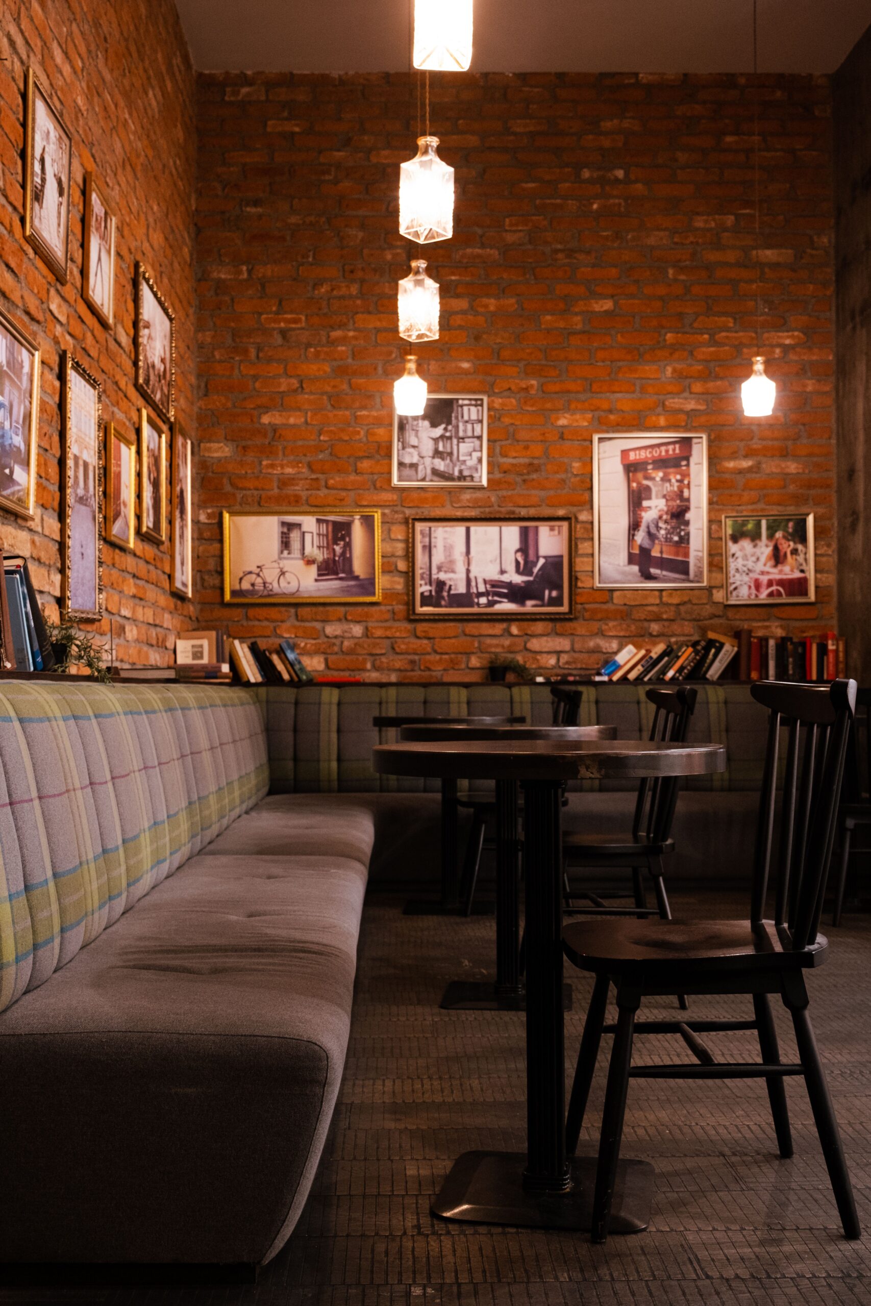 Sfeervol café met bakstenen muur en ingelijste foto's — branding interieur bedrijf Friesland
